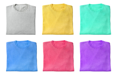 Image of Set of folded warm sweaters on white background, top view