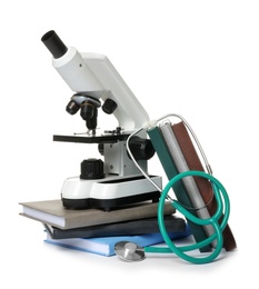 Microscope, stethoscope and books isolated on white. Medical students stuff