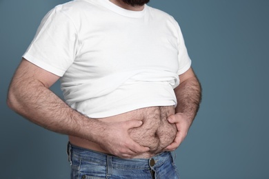 Photo of Overweight man on color background