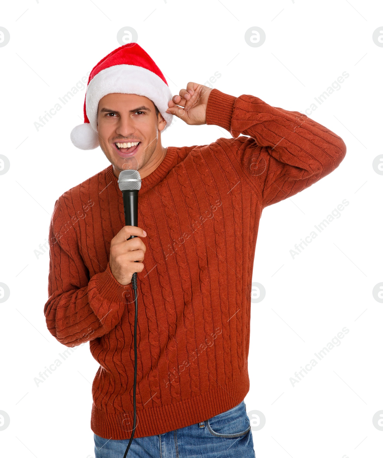 Photo of Emotional man in Santa Claus hat singing with microphone on white background. Christmas music