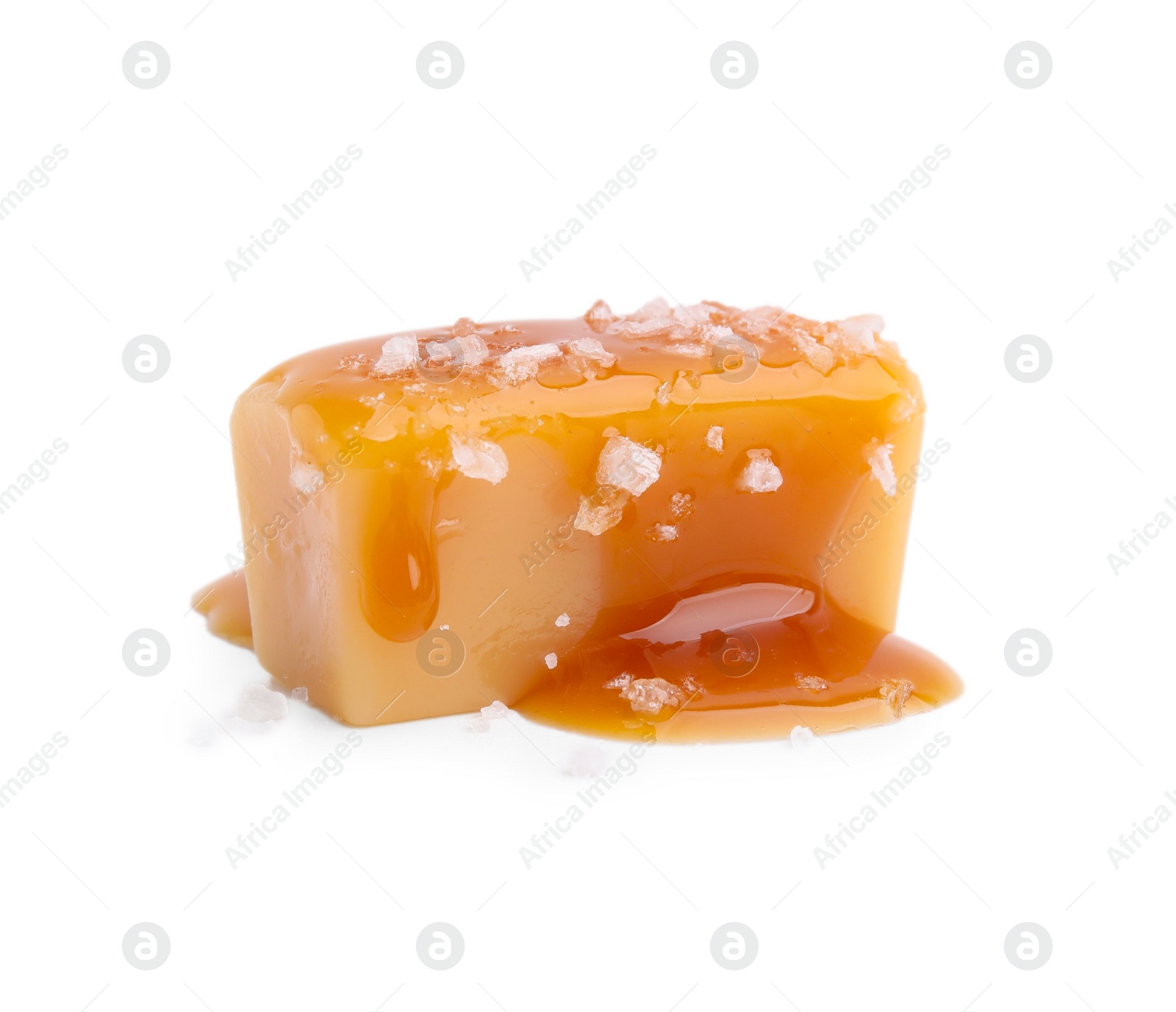 Photo of Yummy caramel candy and sea salt isolated on white