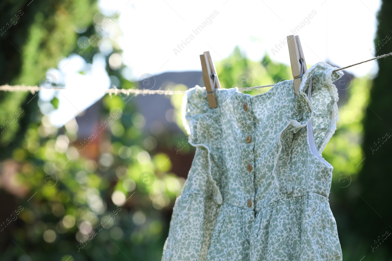 Photo of Dress drying on washing line against blurred background