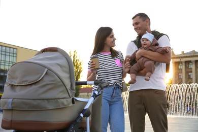 Happy parents walking with their baby outdoors