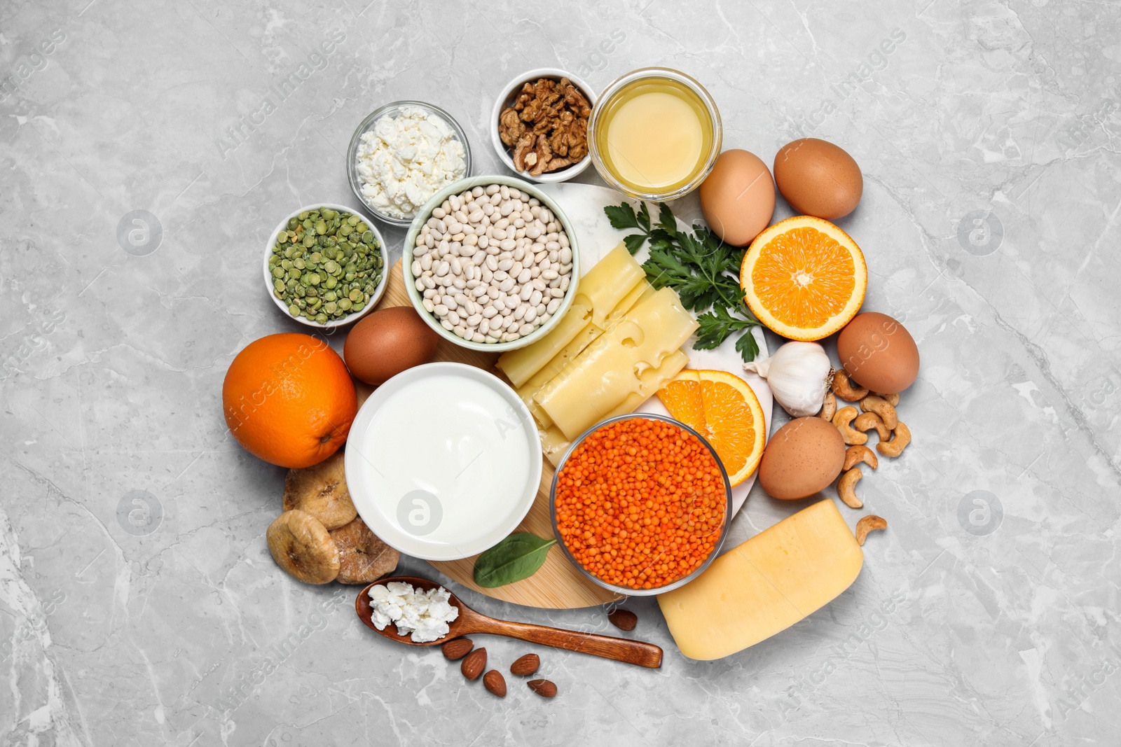 Photo of Set of natural food high in calcium on grey marble table, flat lay