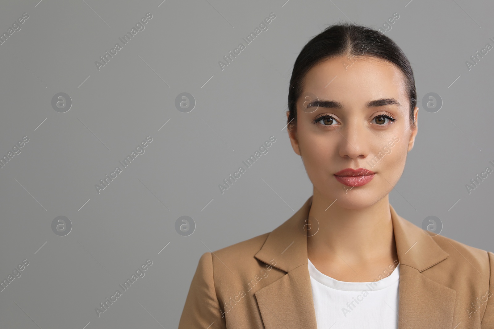 Photo of Portrait of beautiful young woman on grey background, space for text