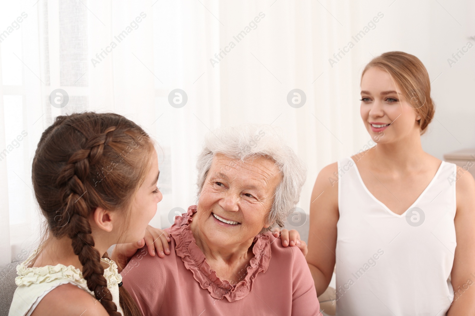 Photo of Happy sisters and their grandmother at home