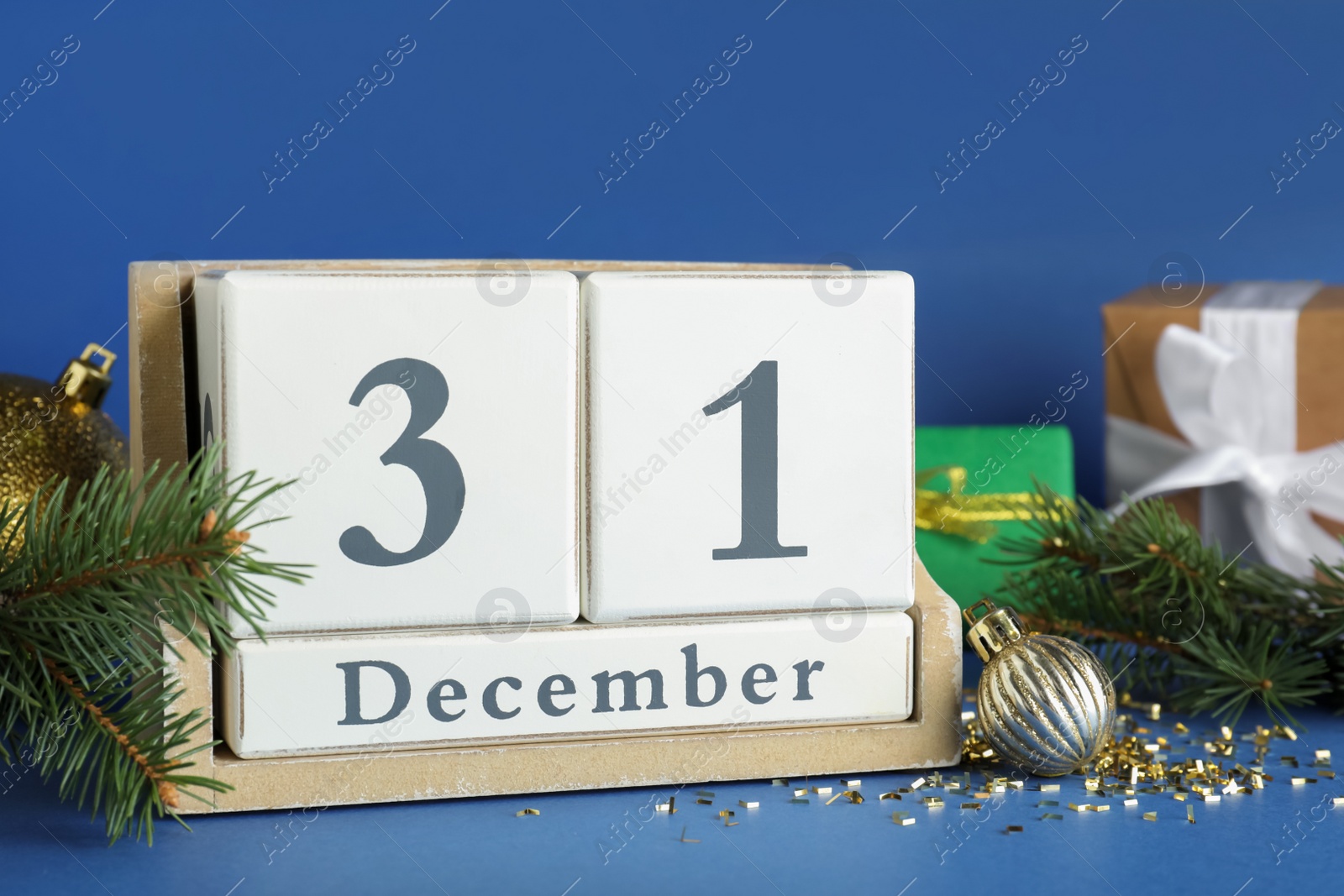 Photo of Block calendar and Christmas decor on blue background. New Year countdown
