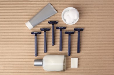 Flat lay composition with shaving accessories for men on cardboard