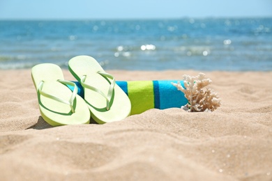 Set of different beach objects on sand near sea