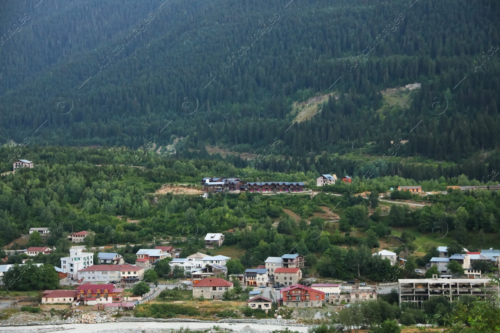 Photo of Picturesque view of small town near mountain forest
