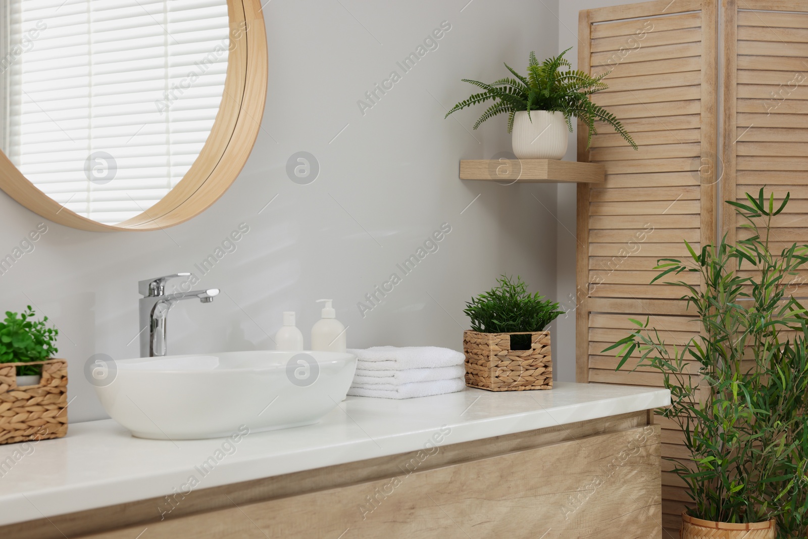 Photo of Different potted artificial plants in bathroom. Home decor