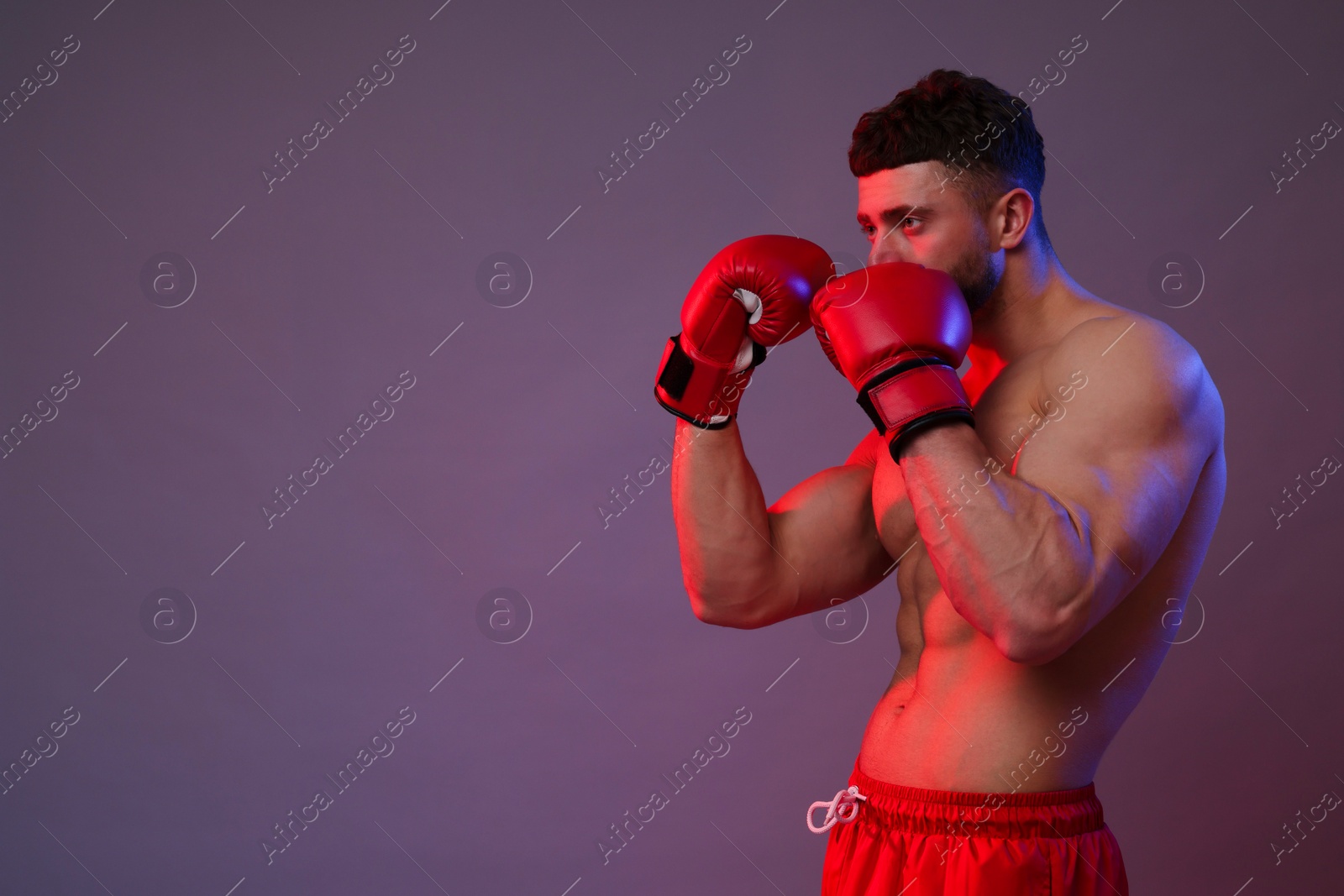 Photo of Man in boxing gloves on color background. Space for text