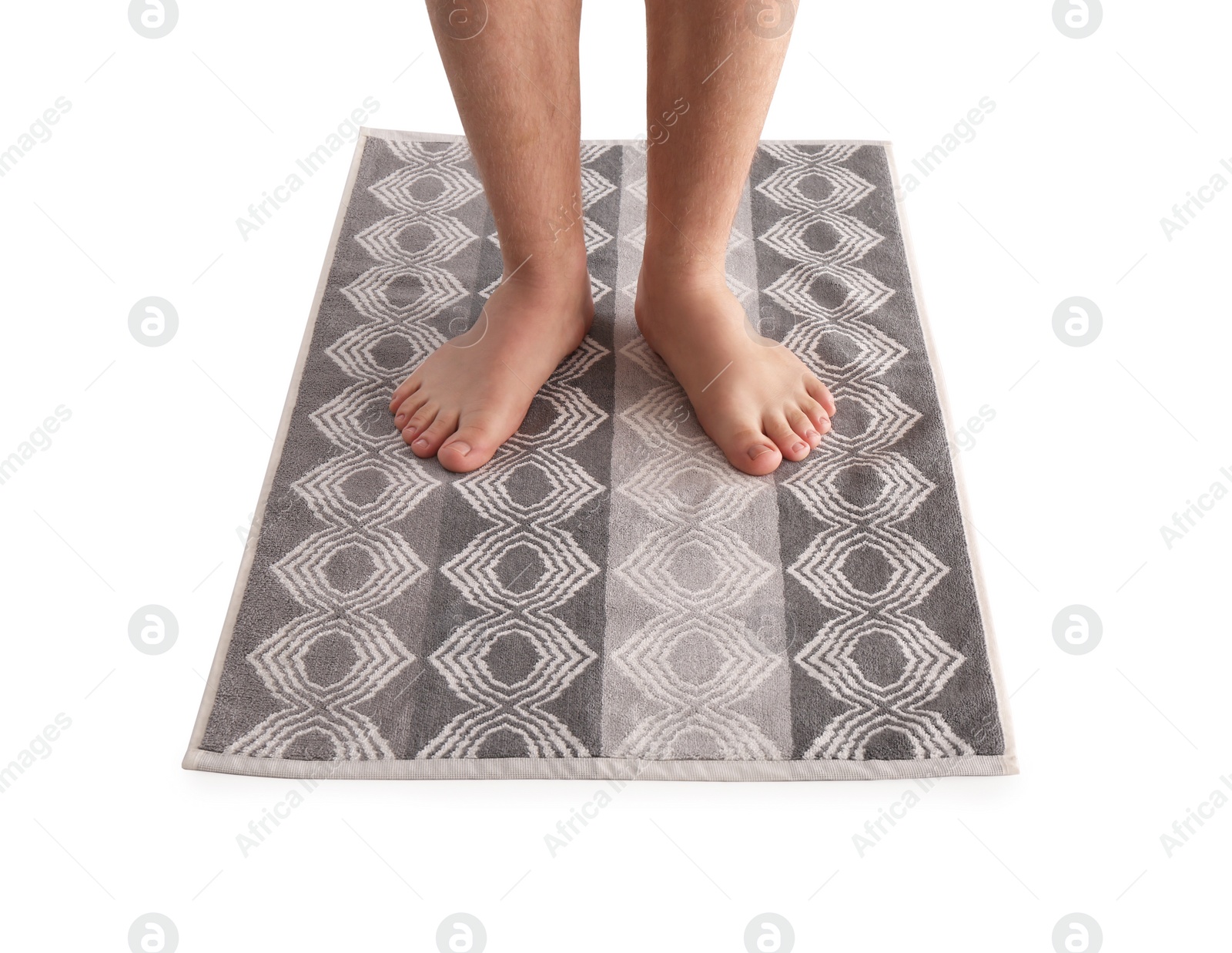 Photo of Man standing on stylish bath mat against white background, closeup