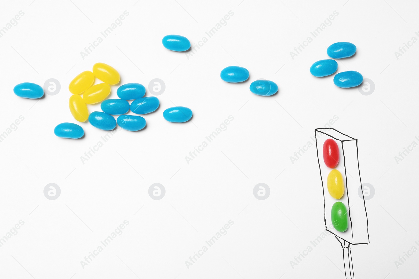 Photo of Colorful jelly candies arranged as traffic light on white background, top view