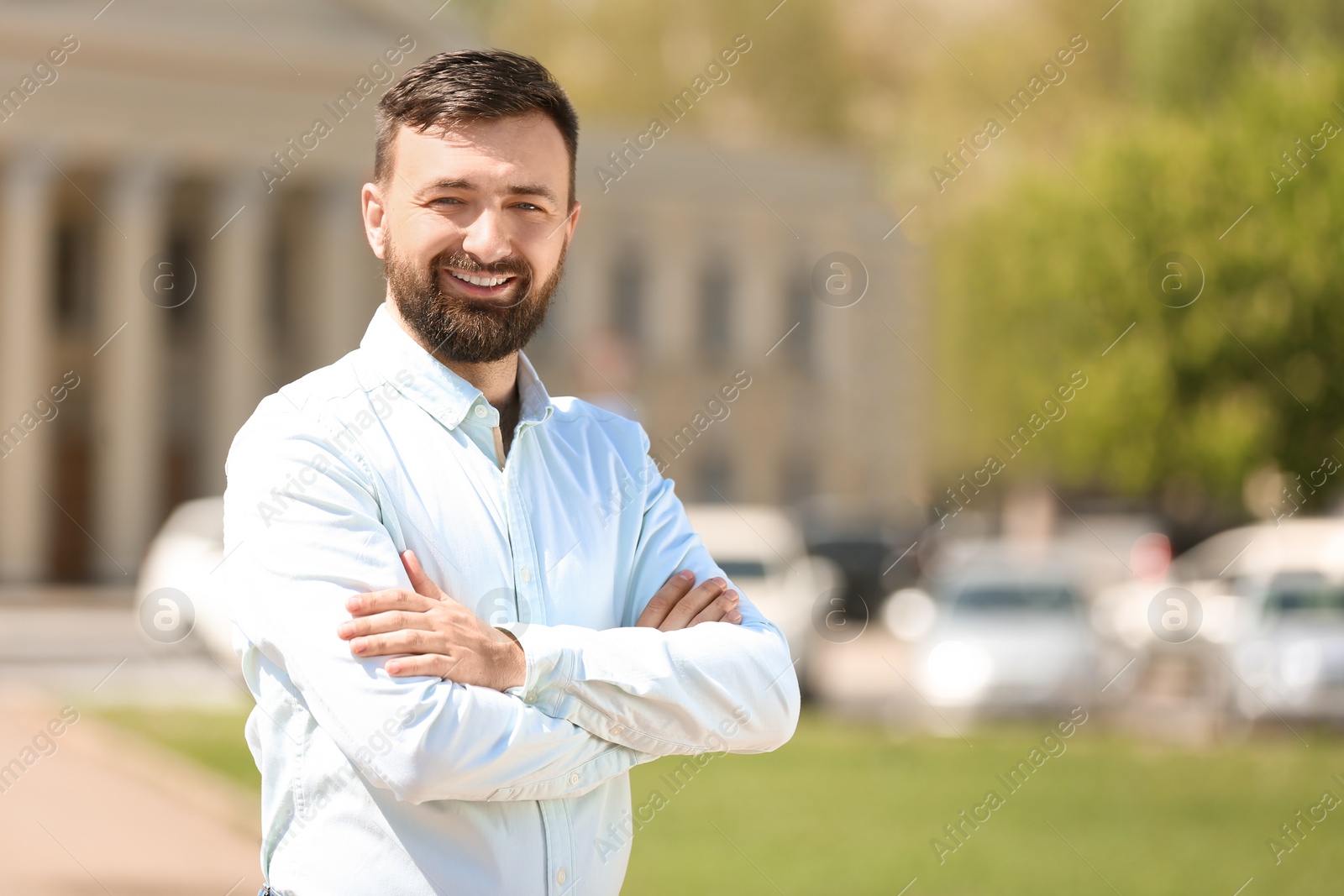 Photo of Portrait of young man in stylish outfit outdoors