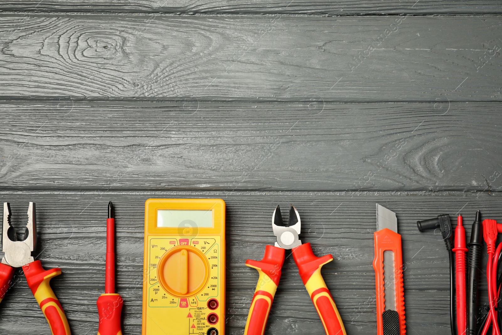 Photo of Flat lay composition with electrician's tools and space for text on wooden background