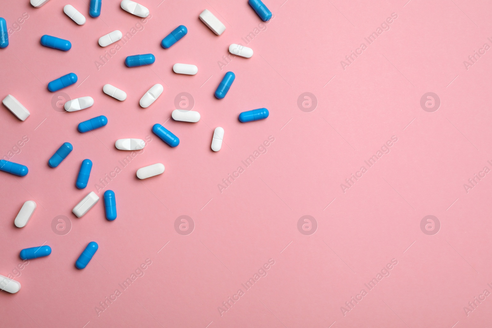 Photo of Different pills and capsules on color background, flat lay