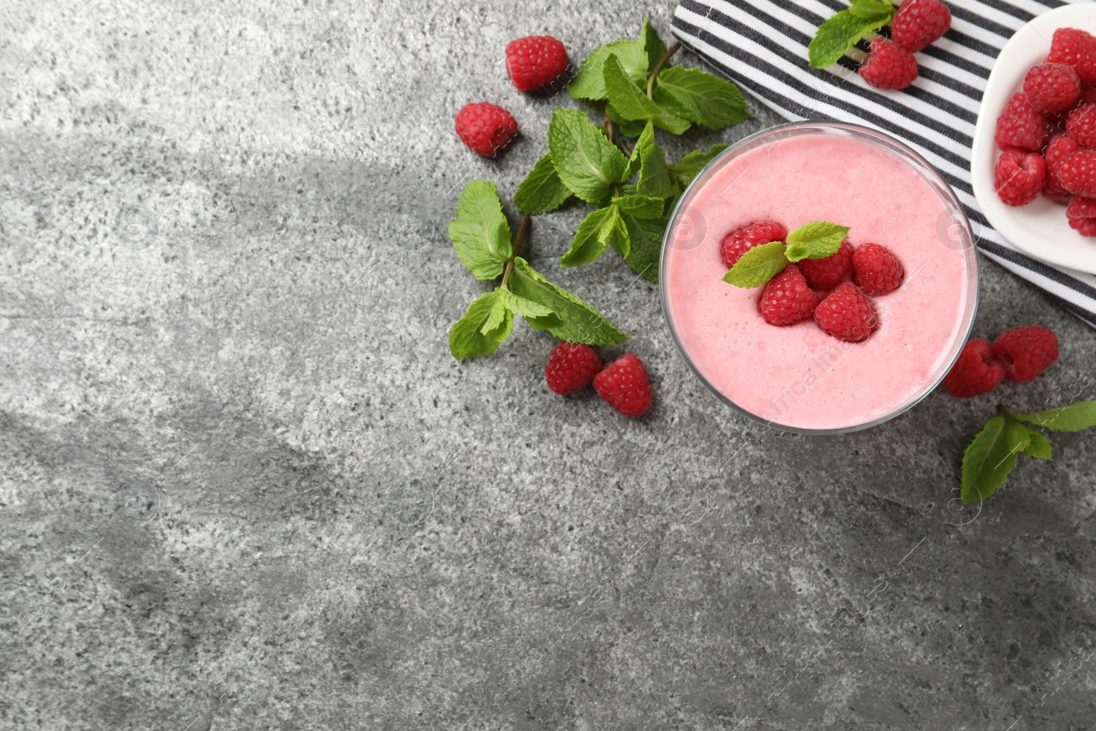 Photo of Delicious raspberry mousse with mint on grey table, flat lay. Space for text