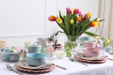 Festive table setting with beautiful flowers. Easter celebration