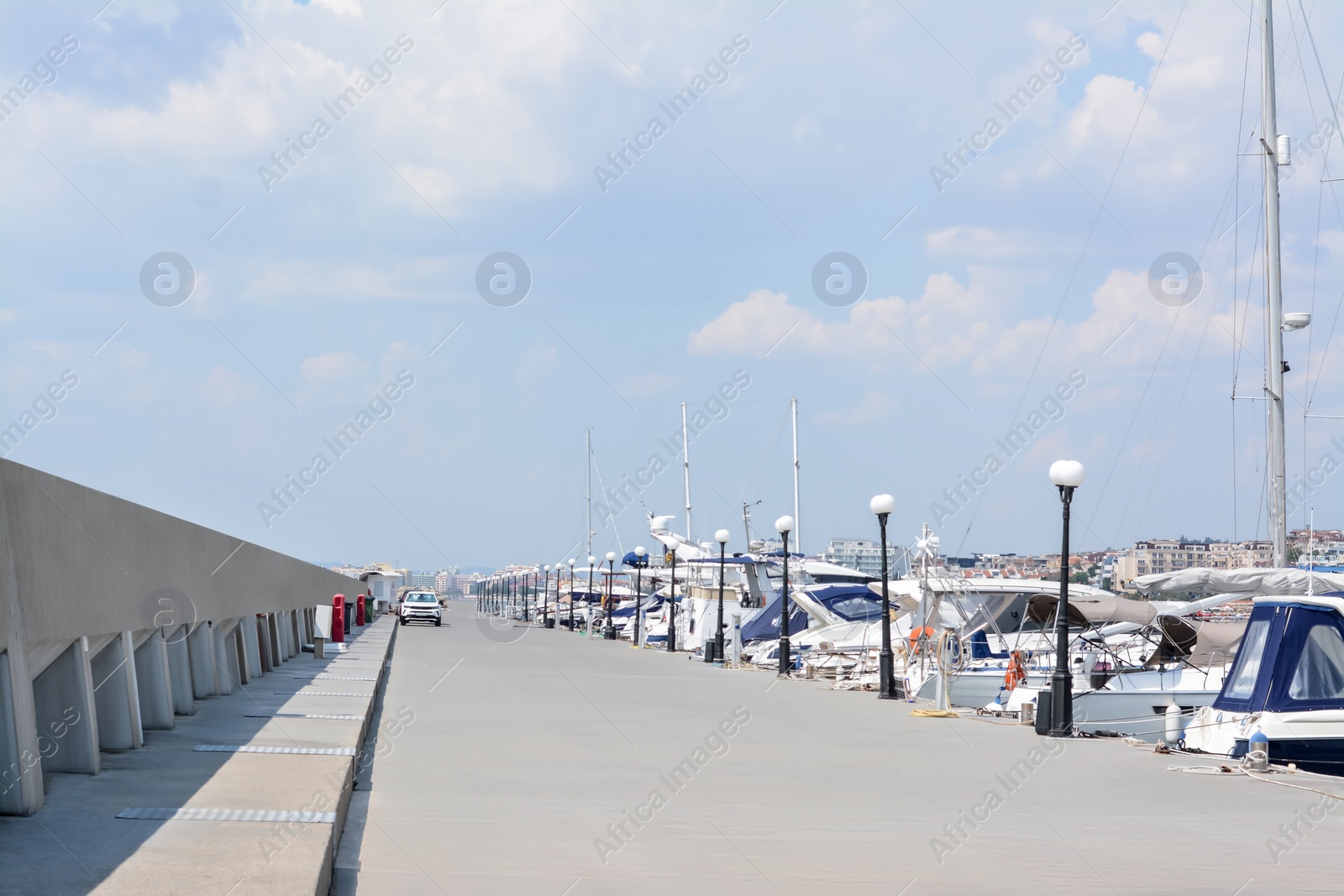 Photo of Beautiful view of city pier with moored boats on sunny day