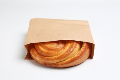 Photo of Paper bag with bun on white background. Space for design