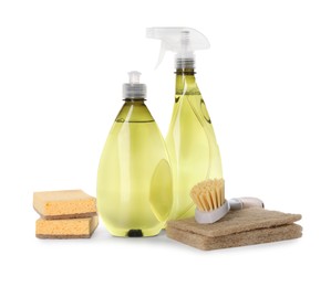 Photo of Bottles of cleaning product, brush and sponges isolated on white