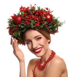 Beautiful young woman wearing Christmas wreath on white background