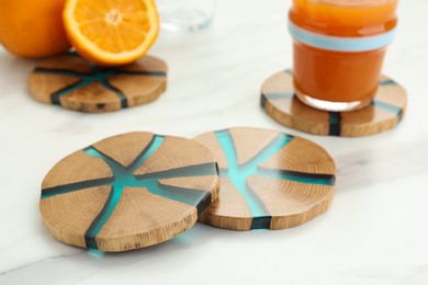 Stylish wooden cup coasters on white table