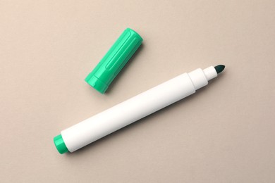 Photo of Bright green marker on beige background, flat lay