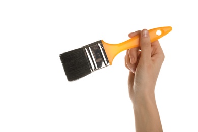 Photo of Woman holding paint brush on white background, closeup