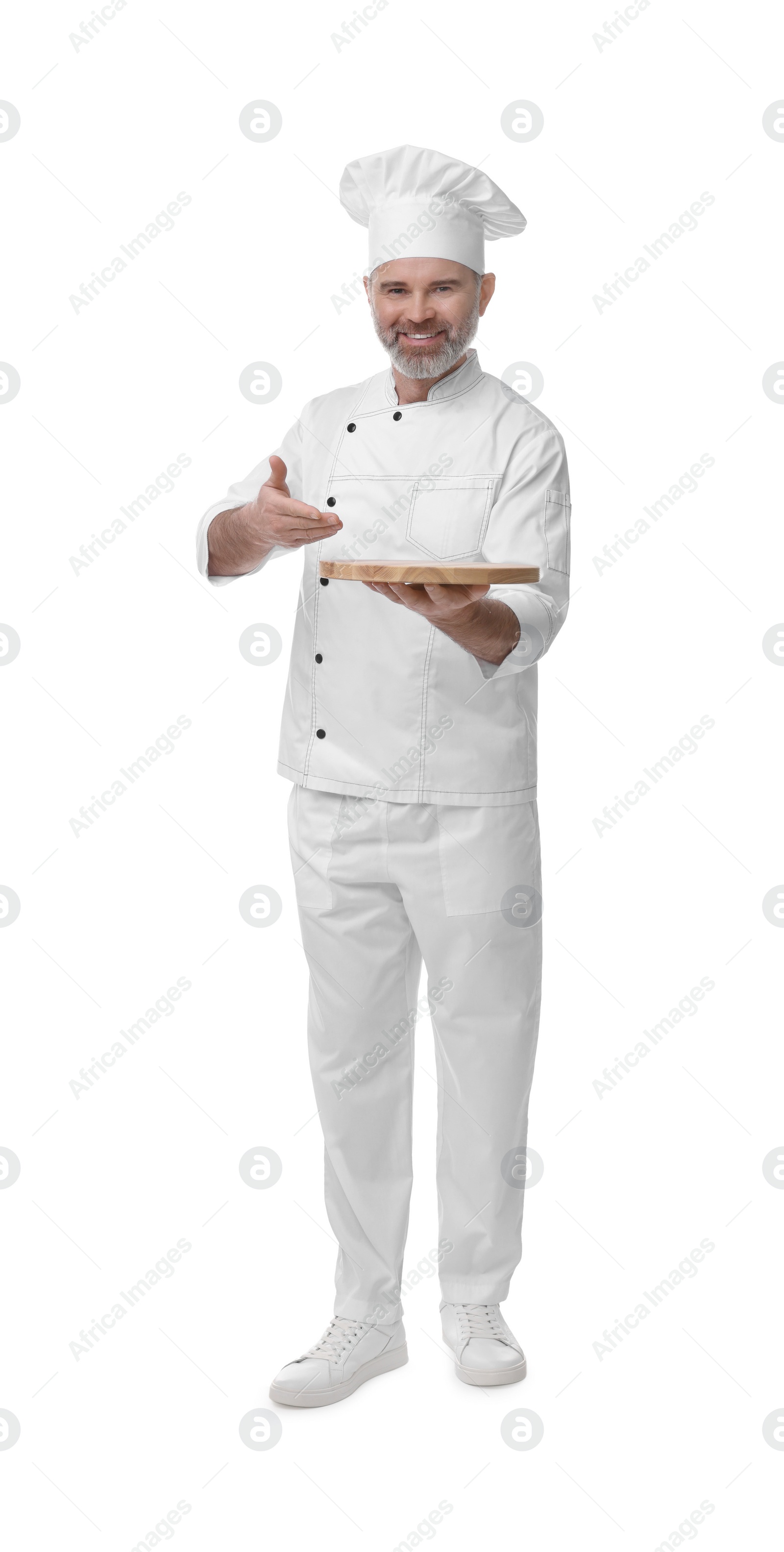 Photo of Happy chef in uniform with wooden board on white background