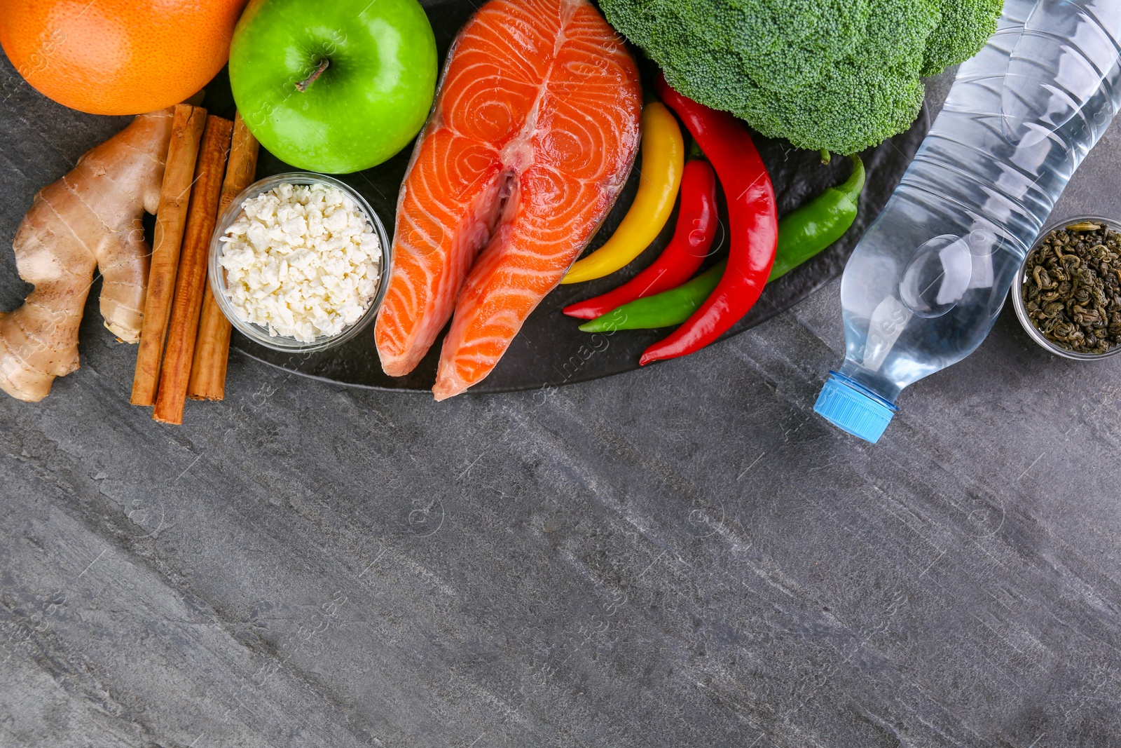 Photo of Metabolism. Different food products on grey table, flat lay with space for text