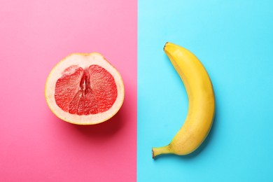 Photo of Banana and half of grapefruit on color background, flat lay. Sex concept