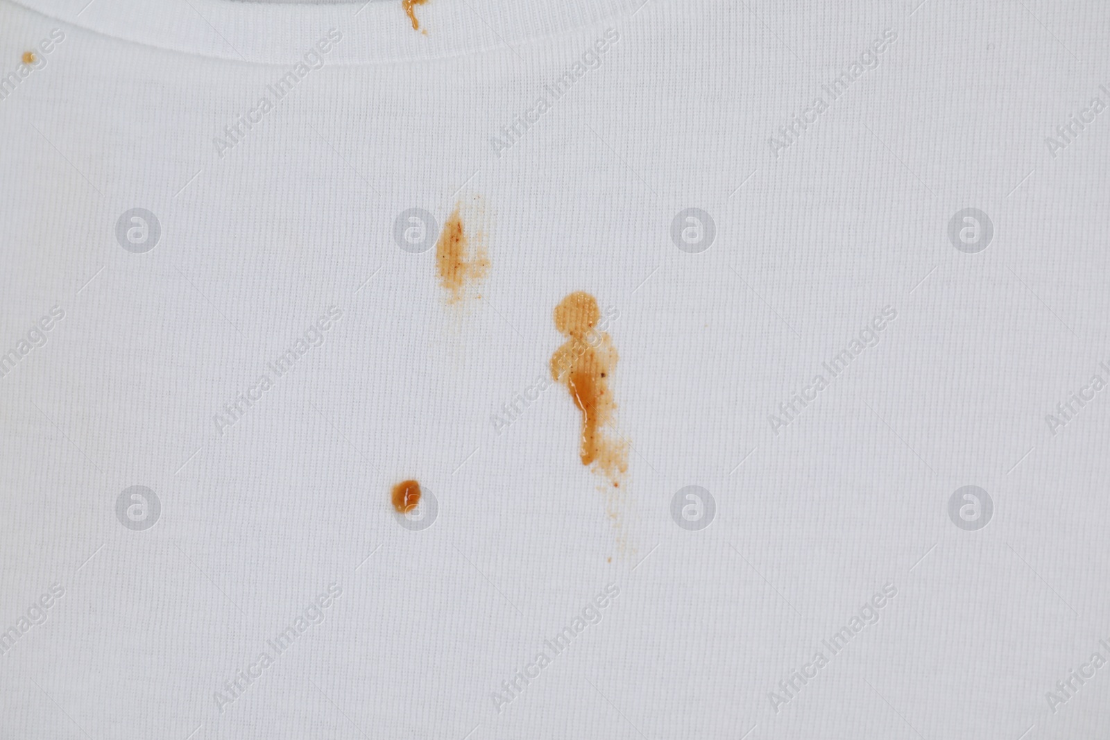 Photo of Stains of sauce on white fabric, top view