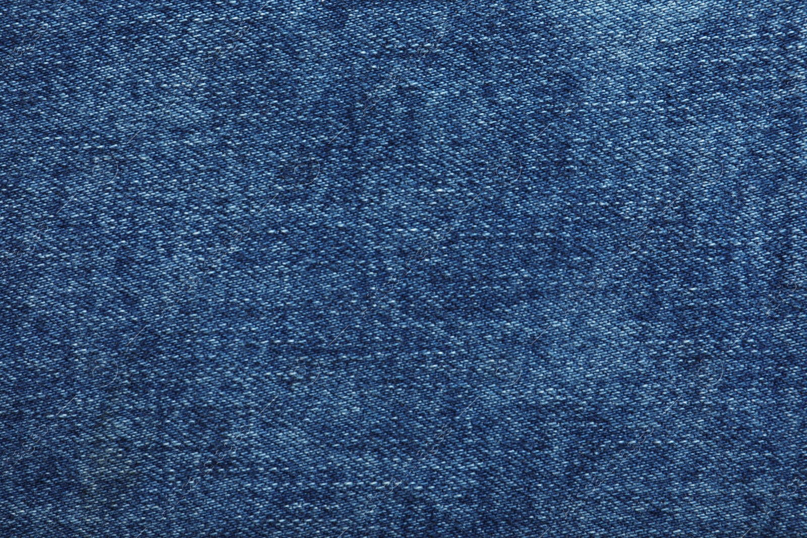 Photo of Texture of dark blue jeans as background, closeup