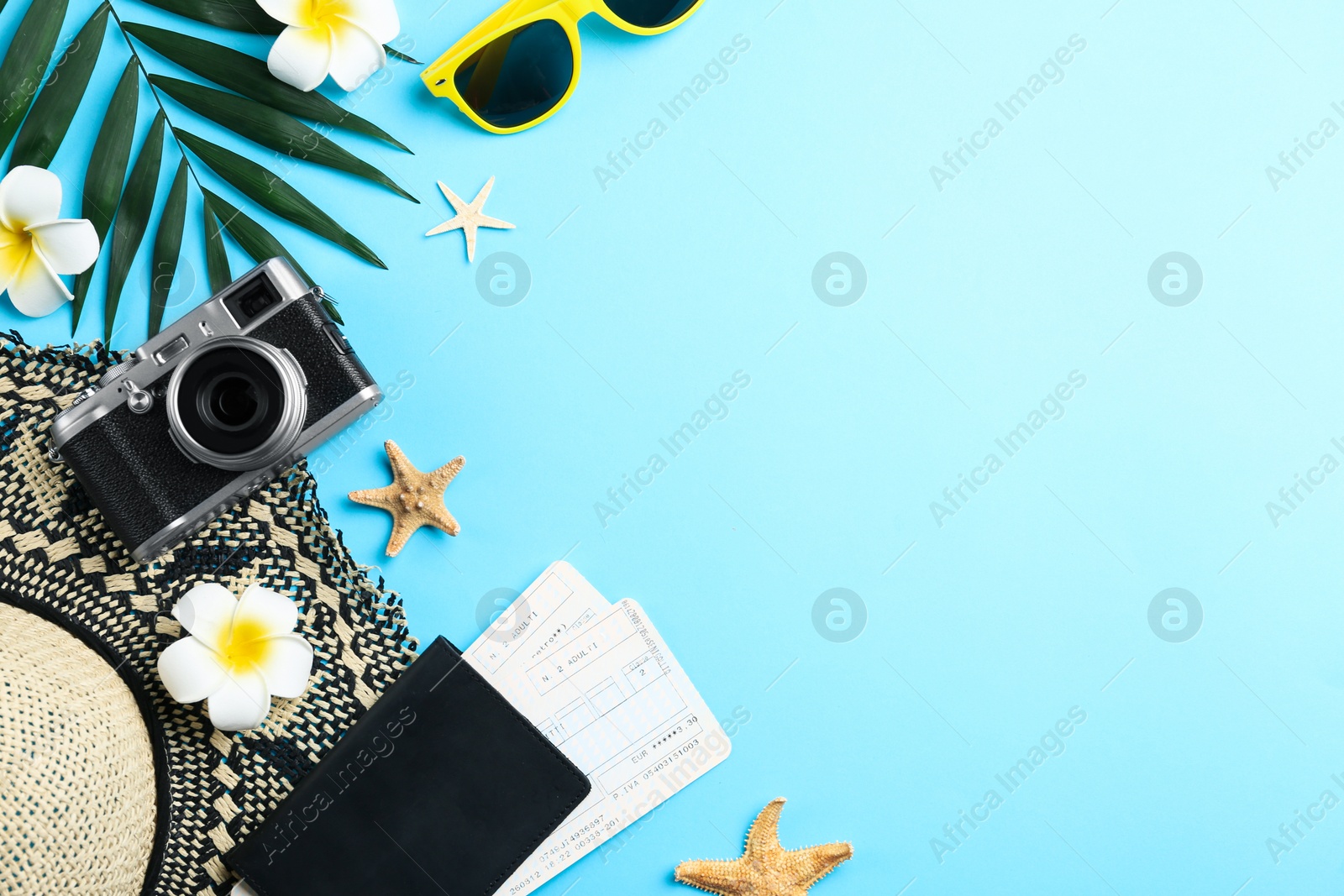 Photo of Flat lay composition with beach objects on light blue background. Space for text