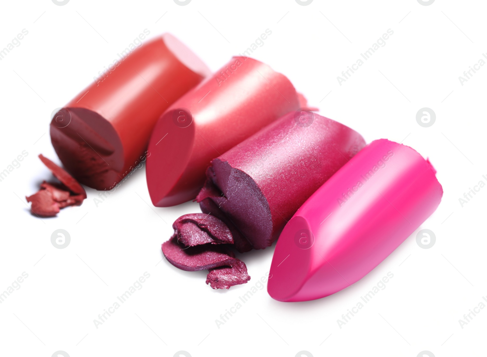 Photo of Many different bright lipsticks on white background