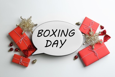 Photo of Speech bubble with phrase BOXING DAY and Christmas decorations on white background, flat lay
