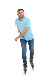 Young man with inline roller skates on white background