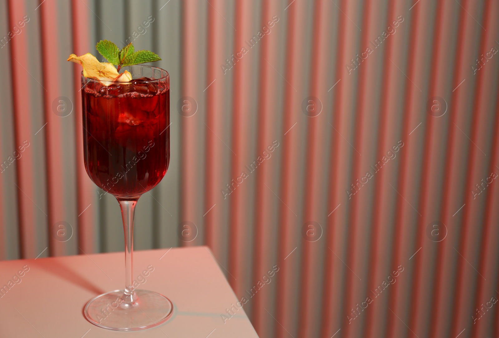 Photo of Glass of delicious cocktail with vodka on white table in bar. Space for text