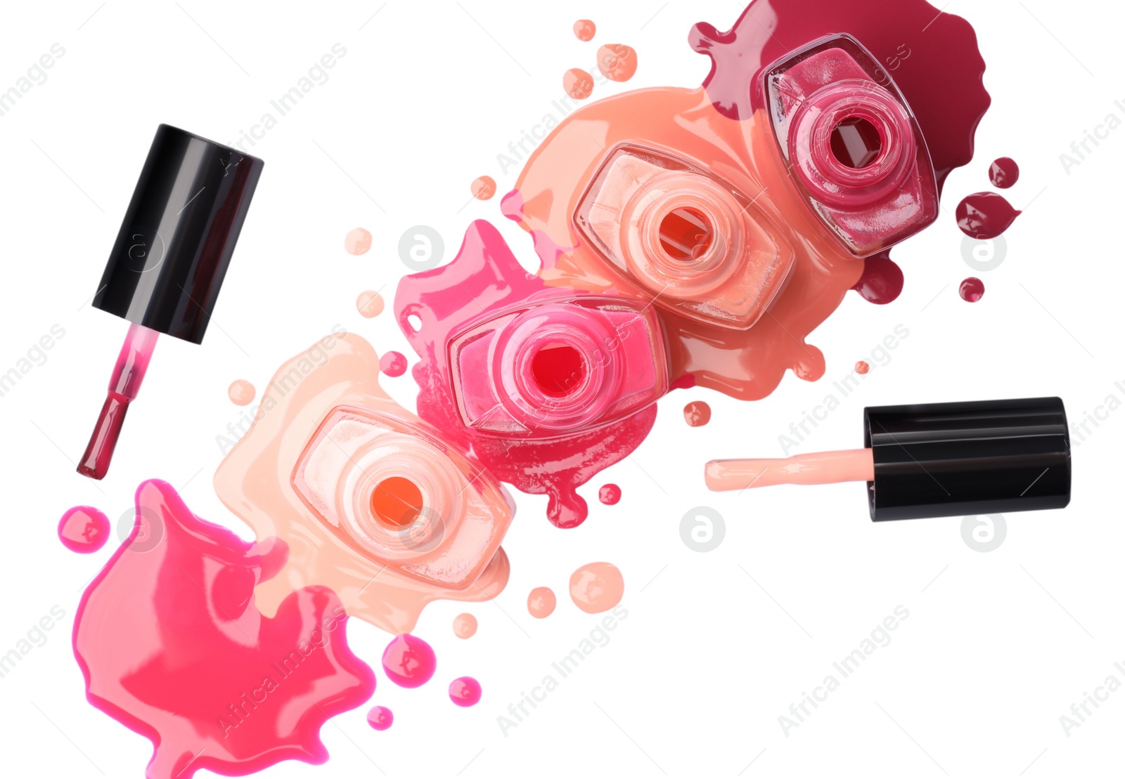 Photo of Many bottles, brushes and drops of colorful nail polishes isolated on white, top view