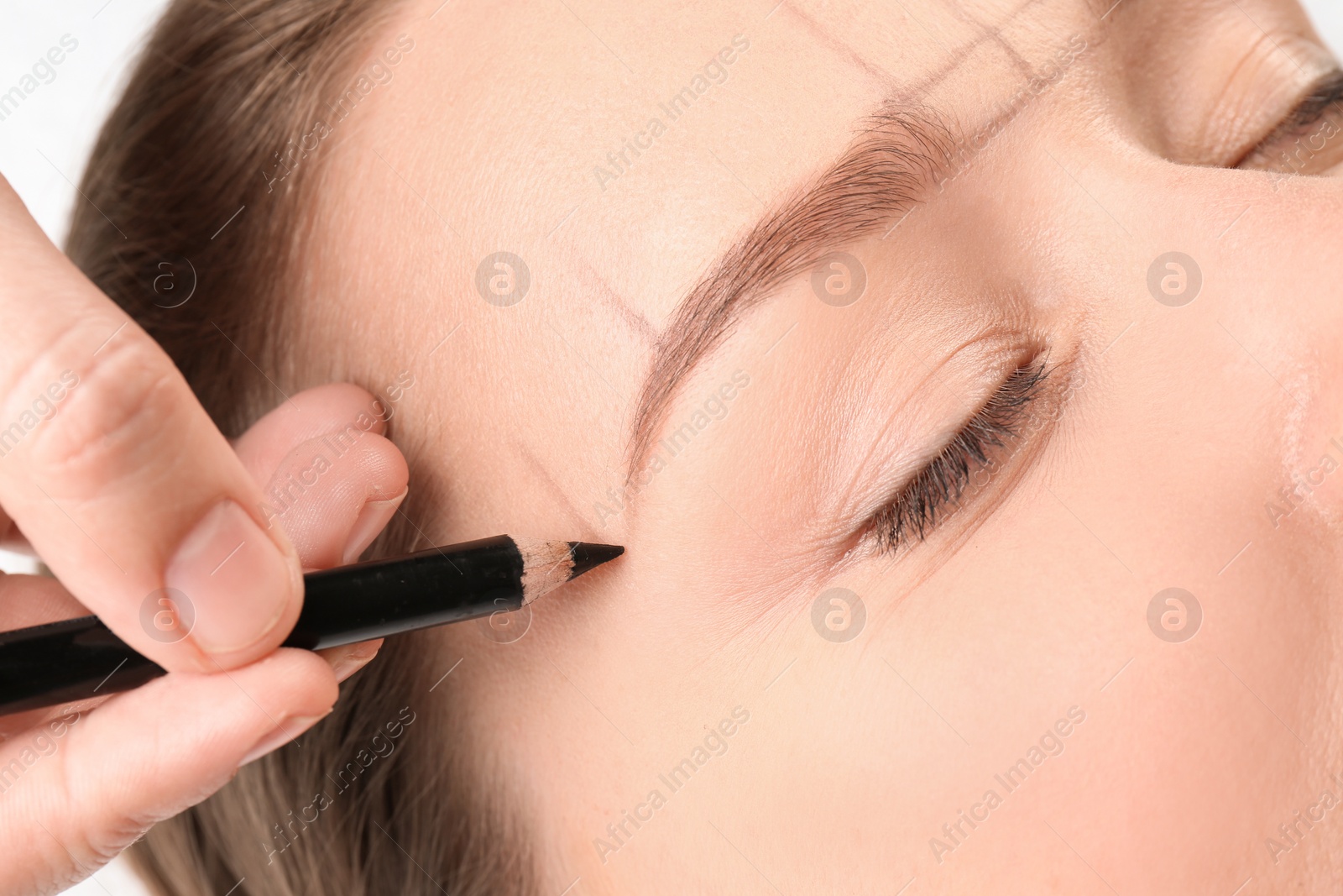 Photo of Young woman having eyebrow correction procedure in beauty salon, closeup