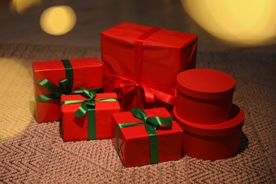 Beautifully wrapped Christmas gifts on rug indoors