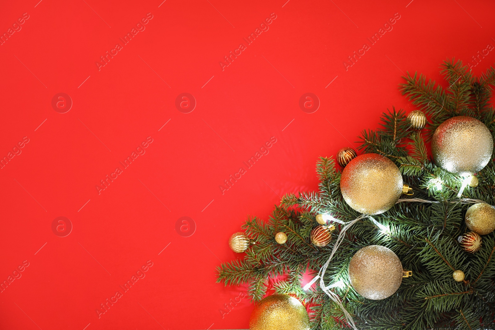 Photo of Christmas decoration on red background, flat lay. Space for text