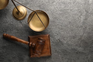 Law concept. Judge's mallet and scales of justice on dark grey table, top view. Space for text
