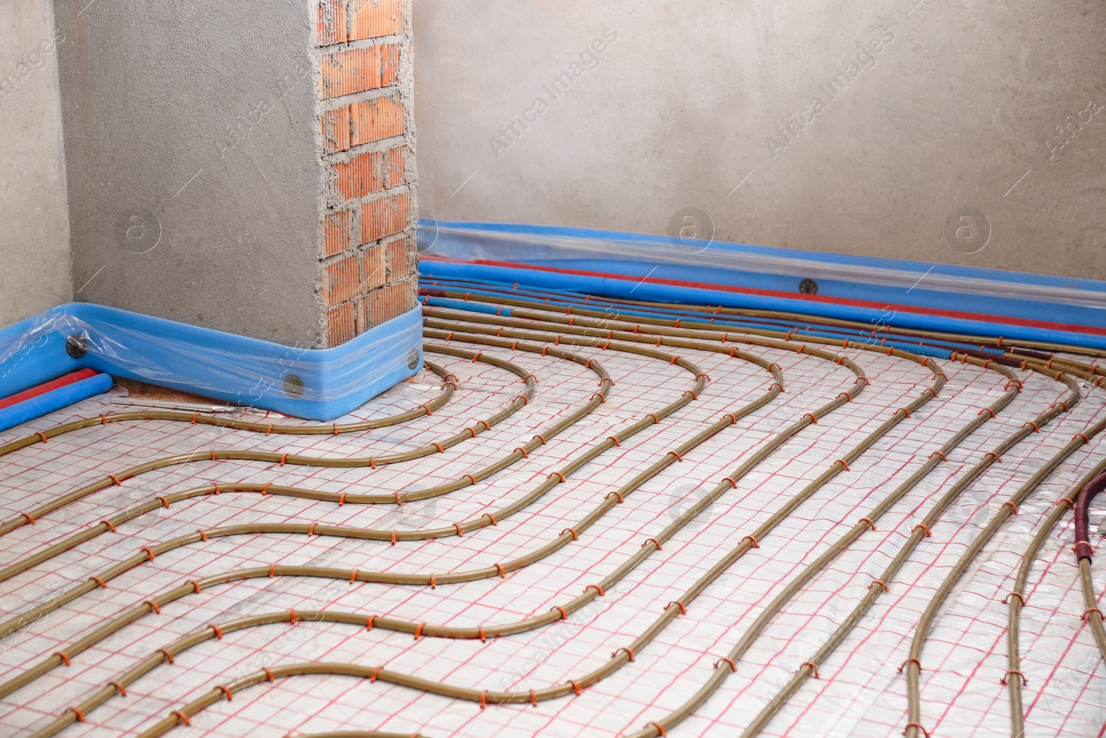 Photo of Installation of underfloor heating system in building