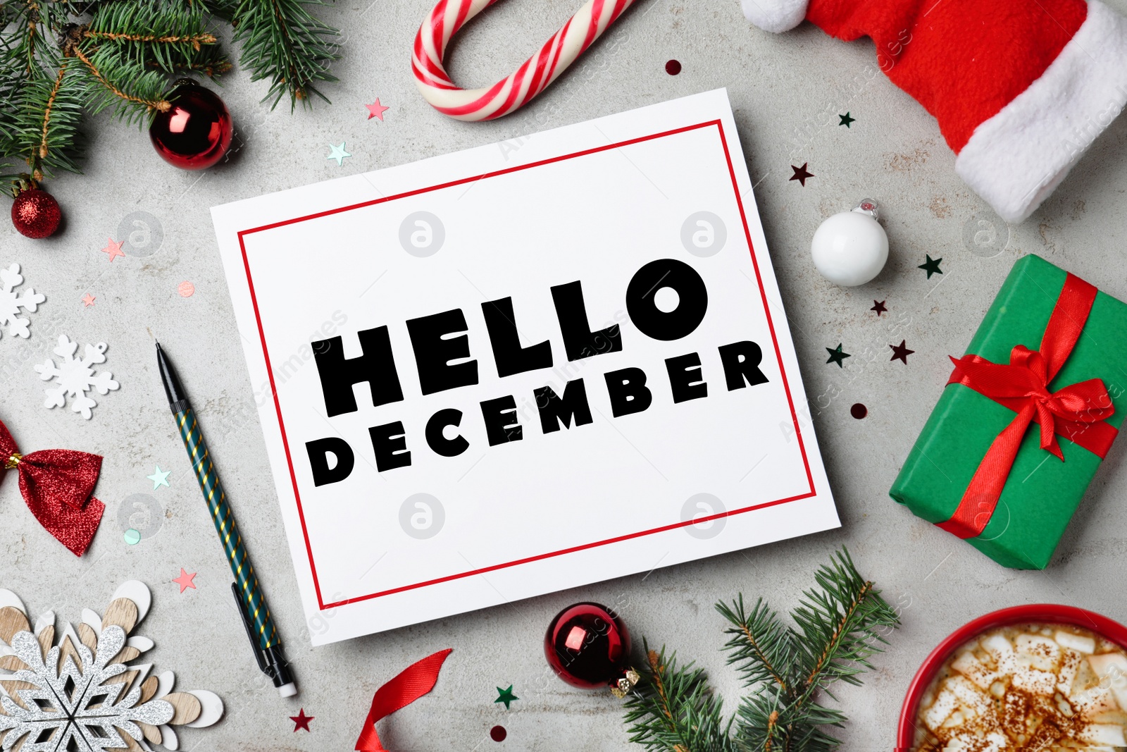 Image of Hello December greeting card. Flat lay composition with Christmas decor on grey background