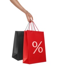 Image of Discount, sale, offer. Woman holding paper bags with percent sign against white background, closeup