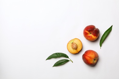 Photo of Flat lay composition with sweet juicy peaches on light background. Space for text