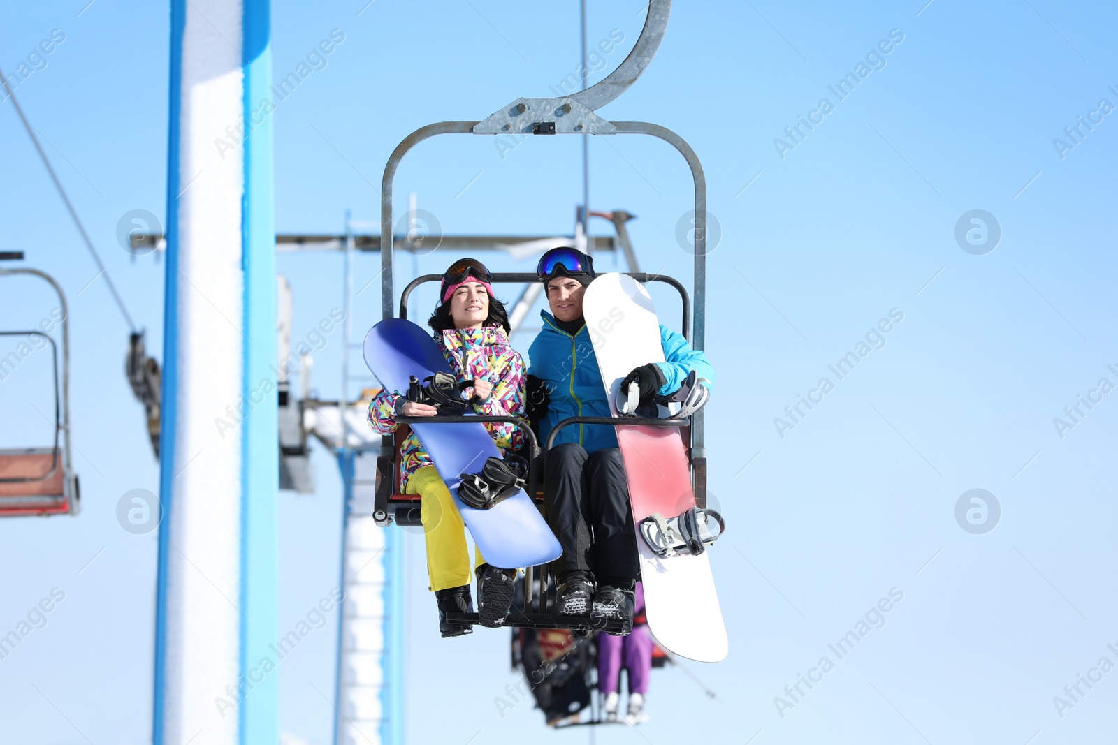 Photo of People using chairlift at mountain ski resort. Winter vacation